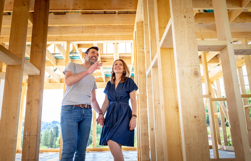 Man and woman looking at a home being built